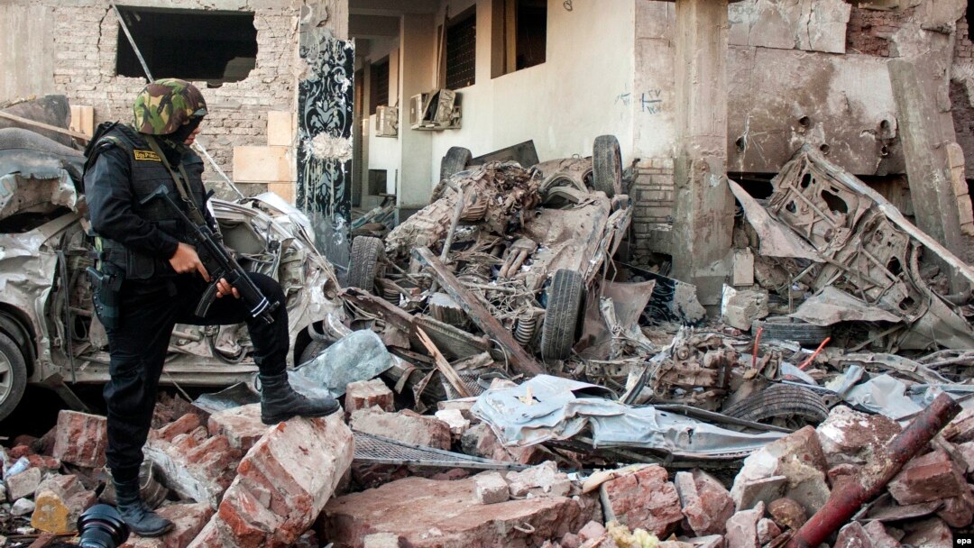 Egyptian security forces inspect the site of a deadly explosion outside police headquarters in Mansoura, Egypt, in December 2013. The Sinai-based militant group Ansar Bayit al-Maqdis had threatened the country's soldiers with death unless they deserted the army.