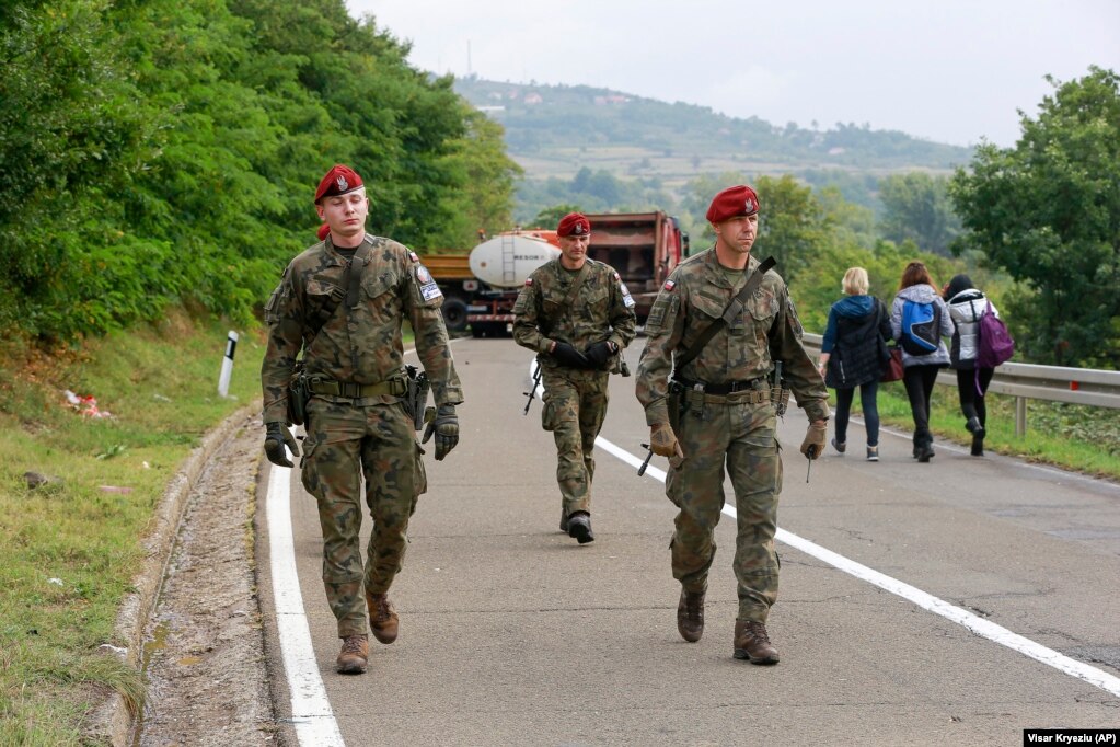 Polish soldiers from KFOR pass through barricades as they patrol near Jarinje on September 28. KFOR is supported by the United Nations, the European Union, and other international actors. Its aim is to stave off lingering ethnic tensions between ethnic Albanians and Serbs.