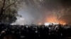 Smoke rises as protesters gather amid evolving anti-government unrest in Mashhad, Iran, on January 10.