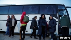 Evacuaees from Mariupol stand outside a bus near a temporary accommodation center in Ukraine's Donetsk region on May 7. 