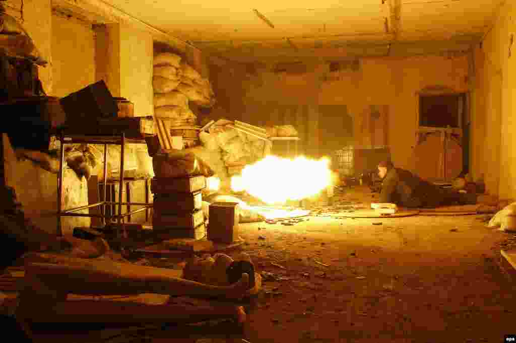 A Ukrainian serviceman fires a machine gun toward Kremlin-backed separatists in an industrial area near Avdiyivka, just north of Donetsk, in November 2016.&nbsp; This is one of thousands of images made by Ukrainian photojournalist Anatoliy Stepanov on the front lines of the ongoing conflict in eastern Ukraine.