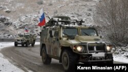 NAGORNO-KARABAKH -- Military vehicles of the Russian peacekeeping force move on the road outside Lachin, November 29, 2020