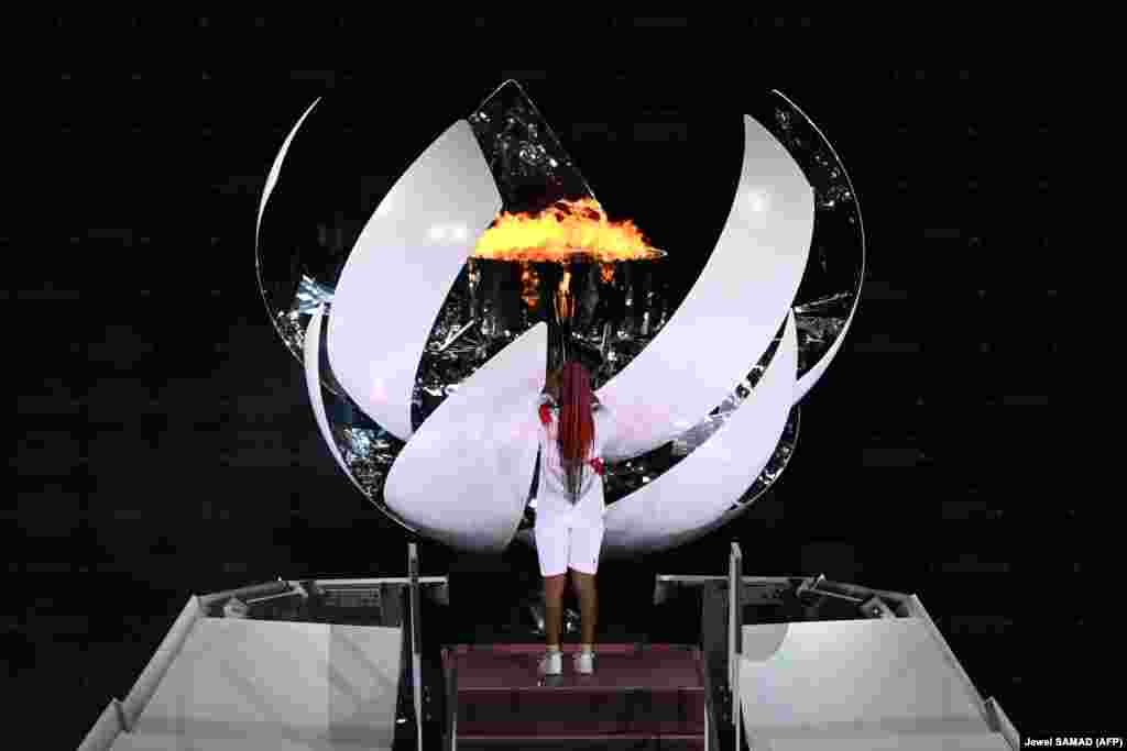 Японская тэнісістка Наомі Осака запальвае агонь надзеі на Алімпійскім стадыёне на цырымоніі адкрыцьця Алімпіяды-2020.