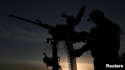 Військовослужбовець мобільного підрозділу ППО 3-ї ОШБр ЗСУ заряджає патрони в кулемет M2 Browning під час бойової зміни на передовій, Харківська область, 15 вересня 2025 року