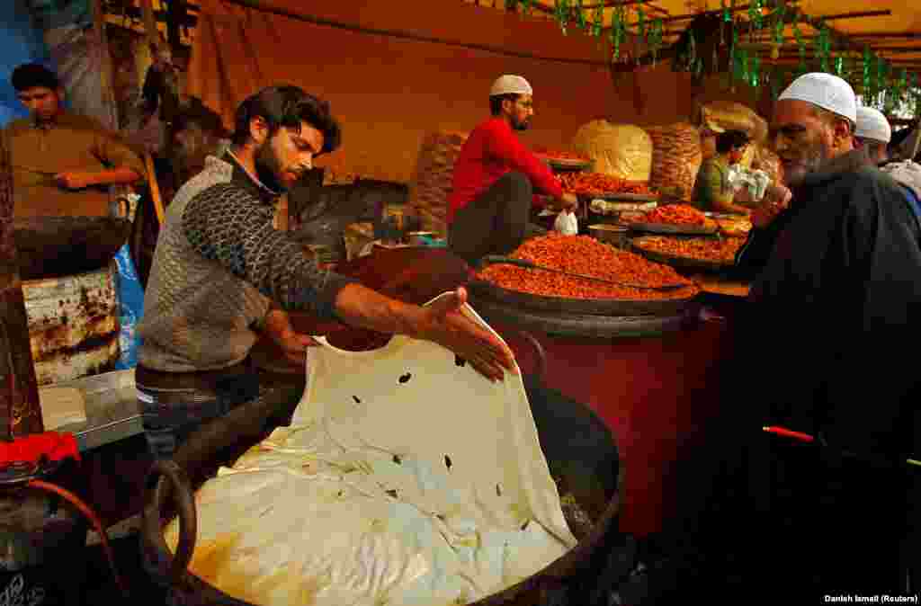 A vendor prepares traditional bread during the festival of Eid-e-Milad-ul-Nabi, the birth anniversary of the Prophet Muhammad, outside the Hazratbal shrine in Srinagar. (Reuters/Danish Ismail)