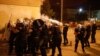 Riot police fire tear gas in front of a police station in Podgorica, Montenegro on June 24.