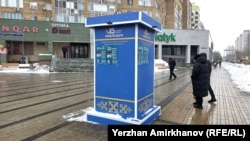 Жаңа Конституция жобасы туралы референдум жарнамасы ілінген маңнан өтіп бара жатқан адамдар. Астана, 6 наурыз, 2026 жыл.