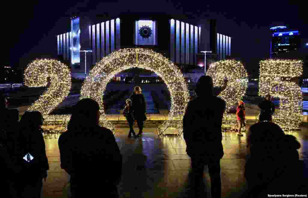 People look at Christmas decorations in front of the National Palace of Culture in Sofia, Bulgaria.&nbsp;