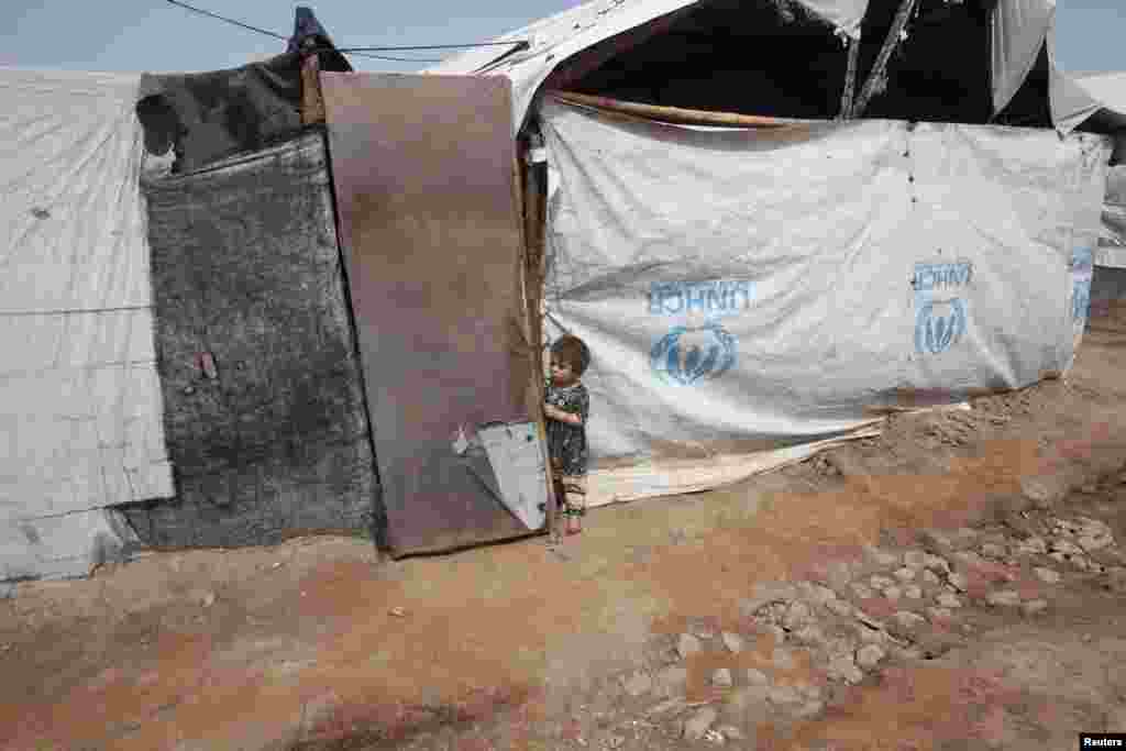 A child stands outside her family&#39;s tent near the site of a bomb attack in the Jalozai refugee camp in Pakistan&#39;s Nowshera district. (Reuters/Fayaz Aziz)