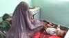 AFGHANISTAN MALNUTRITION -- An Afghan woman sits next to child suffering from malnutrition at Mirwais hospital in Kandahar. 