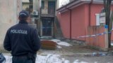 A police officer stands guard at the scene of a deadly shooting incident in Cetinje which occurred in the Montenegrin city late on January 1. 