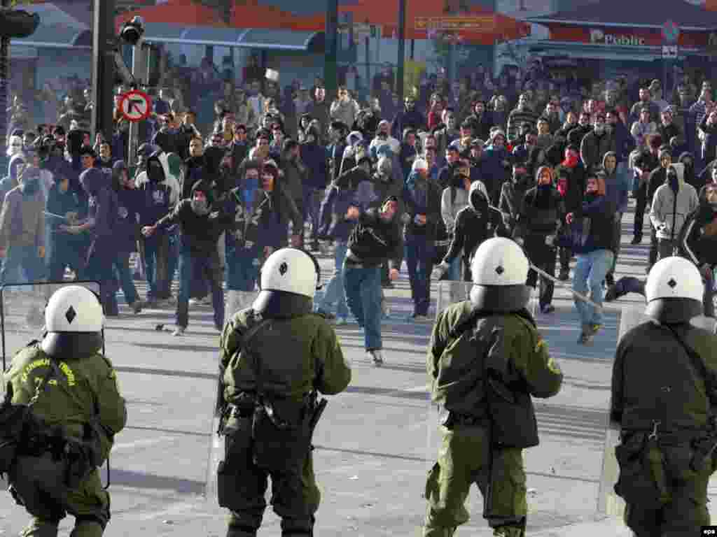 Greece wracked by protests. - High school students clash with riot police outside the Greek parliament building in Athens, Greece on 09 December 2008.