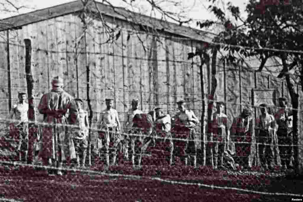 An undated photo shows Germans soldiers captured during the Battle of Verdun. They are removing their clothes for a body search by French soldiers.