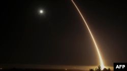 A streak of light trails off into the night sky as the U.S. military test-fires an unarmed intercontinental ballistic missile at Vandenberg Air Force Base, northwest of Los Angeles, California, in 2017.