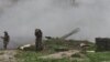 Nagorno-Karabakh -- Armenian servicemen of the self-defense army of Nagorno-Karabakh fire an artillery shell towards Azeri forces from their positions in the town of Martakert , April 3, 2016