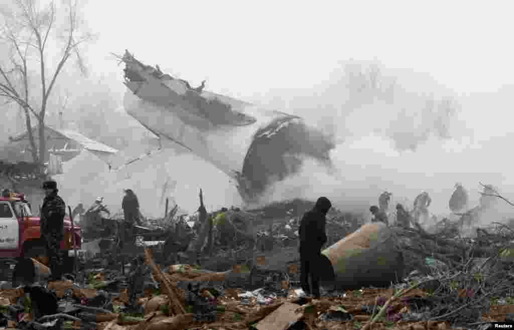 Rescue teams are seen at the crash site of a Turkish cargo jet near Manas airport outside Bishkek, Kyrgyzstan, on January 16. More than 30 people died in the incident.&nbsp;(Reuters/Vladimir Pirogov)