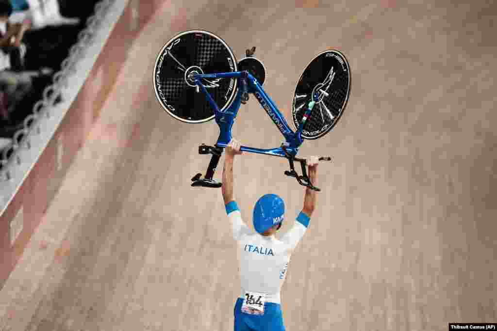 Filippo Ganna of Team Italy celebrates after winning the gold medal during the track cycling men's team pursuit at the 2020 Summer Olympics, Wednesday, Aug. 4, 2021, in Izu, Japan. 