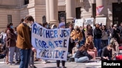 Demonstranti se okupljaju na uglu ulica Grove i Koledž nakon što je razbijen kamp na Plazi. Propalestinski demonstranti pozivali su Jejl da prekine finansijske veze sa investitorima - proizvođačima oružja, u Nju Hejvenu, Konektikat, 22. aprila 2024. 