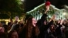 Supporters of Bucharest Mayor Nicusor Dan cheer as he exits his campaign headquarters in Bucharest after winning a presidential election on May 18.