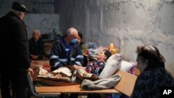 NAGORNO-KARABAKH -- A medical worker talks to a sick woman in a bomb shelter in Stepanakert, October 22, 2020