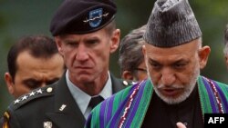 U.S.General Stanley McChrystal (left) with Afghan President Hamid Karzai at Arlington National Cemetery during a Washington visit in mid-May.