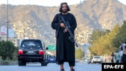 A Taliban security member stands guard following an attack by rival Islamic State-linked fighters last month.