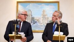 German Foreign Minister Frank-Walter Steinmeier (left) and his French counterpart Jean-Marc Ayrault brief journalists after the talks on the crisis in eastern Ukraine in Minsk on November 29.