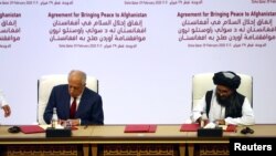 Mullah Abdul Ghani Baradar, the leader of the Taliban delegation (right), signed an agreement with Zalmay Khalilzad, U.S. envoy for peace in Afghanistan, in Doha on February 29.