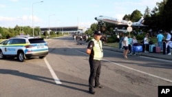 Passengers are evacuated from Chisinau airport in Moldova on June 30 after a shooting incident left two people dead. 