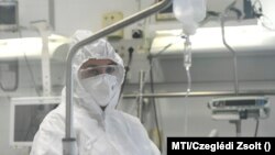 Egészségügyi dolgozó egy remdesivir hatóanyagot tartalmazó szerrel kezelt beteg mellett a debreceni Kenézy Gyula Kórházban, 2020. október 15-én.