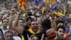 People react towards a giant screen showing events inside the Catalan regional parliament during a pro-indpendence rally outside the parliament in Barcelona, Spain October 10, 2017