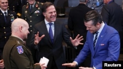 NATO Secretary-General Mark Rutte (center) shares a laugh with U.S. Defense Secretary Pete Hegseth (right) and Commander of United States European Command and Supreme Allied Commander Europe, Army General Christopher G. Cavoli during a meeting of NATO defense ministers in Brussels on February 13.