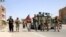 Armed Afghan security officers stand guard at a checkpoint in Herat's Guzara district on July 30. 