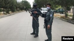 Afghan police stand guard near the site of an attack in Kabul on June 12.