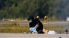 A police officer wearing protective clothing examines evidence at Germany's Leipzig Airport on August 5 after two incidents involving drones occurred. 