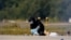 A police officer wearing protective clothing examines evidence at Germany's Leipzig Airport on August 5 after two incidents involving drones occurred. 