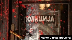 Red paint is sprayed on a door during a protest over the collapse of a canopy at a railway station in the Serbian city of Novi Sad. 