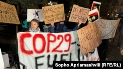 Swedish environmental activist Greta Thunberg (left) protests in Tbilisi on November 11 against COP 29 being held in Baku, Azerbaijan.