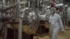  An Iranian security official in protective clothing walks through part of the Uranium Conversion Facility just outside of Isfahan. (file photo)