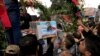 Iranian mourners carry the coffins of three members of the Revolutionary Guards reportedly killed in Syria during their funeral in Tehran in June.