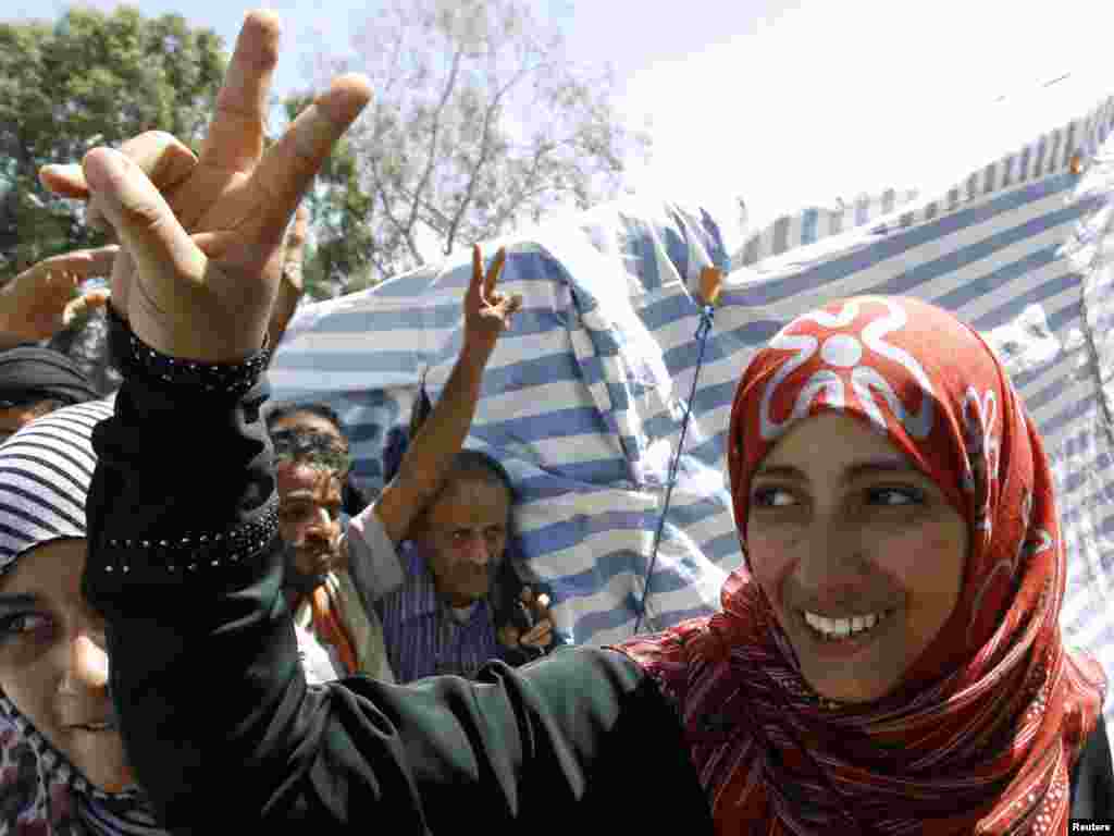 Yemeni Nobel Peace Prize winner Tawakul Karman flashes a victory sign outside her tent on Tagheer Square in Sanaa on October 7. (Photo by&nbsp;Ahmed Jadallah for Reuters)