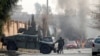 Afghan police officers arrive at the site of a blast and gun fire in Jalalabad on January 24.