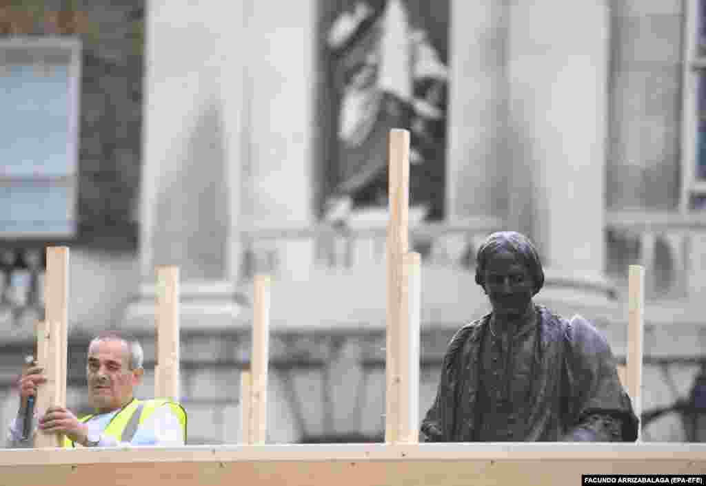 A statue of Thomas Guy is being boarded up at Guys Hospital in London, Britain, 12 June 2020. Thomas Guy founded Guys hospital and made his fortune from business involving selling slaves. London&#39;s Mayor, Sadiq Khan, said the capital&#39;s landmarks would be reviewed by a commission to removing those with links to slavery.