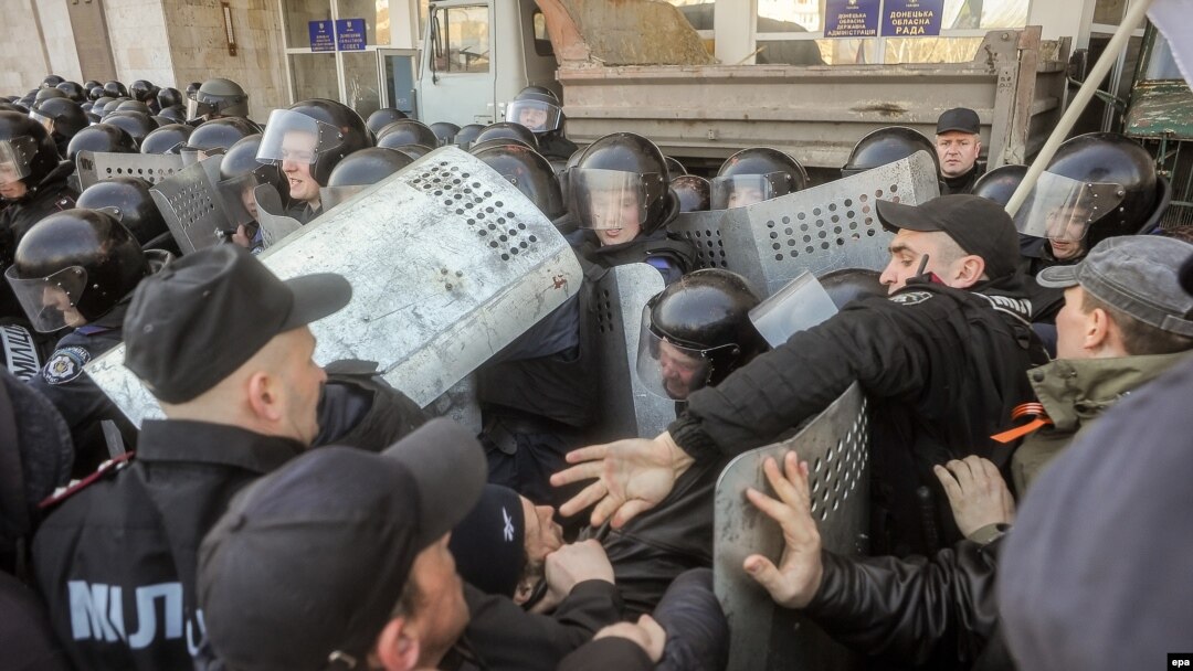 Pro-Russian protesters clash with police as they try to occupy a regional administration building in Donetsk earlier this week. Russian media are reporting that staff from a U.S. military contractor have been assisting Kyiv authorities in eastern Ukraine. 