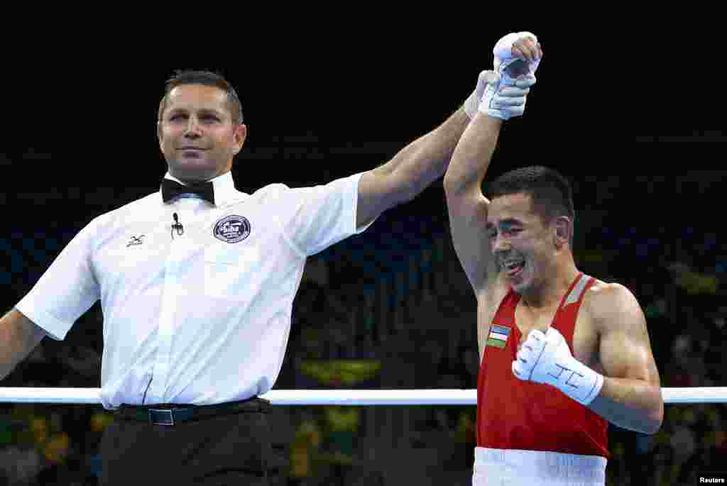 Hasanboy Dusmatov of Uzbekistan reacts after winning his semifinal bout in the men&#39;s light fly (49 kilograms) boxing.