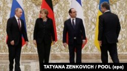 Russian President Vladimir Putin (left to right), German Chancellor Angela Merkel, French President Francois Hollande, and Ukrainian President Petro Poroshenko prepare to pose for the media during a group photo opportunity at the Ukraine crisis meeting in Minsk on February 11.