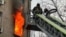 A Ukrainian firefighter tackles a blaze in a residential building following a Russian drone attack on Kyiv on January 1. 