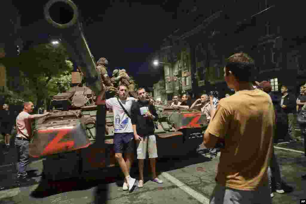 Civilians pose for photos as members of the Wagner mercenary group sit atop their tank in&nbsp;Rostov-on-Don.&nbsp; On June 23, the Wagner mercenary group entered Russia from Ukrainian territory in order to seize the Southern Military District&#39;s administrative center. Prigozhin claimed that a missile had struck a Wagner camp in Ukraine &quot;from the rear&quot; and charged the Russian military with carrying out the attack. &nbsp;