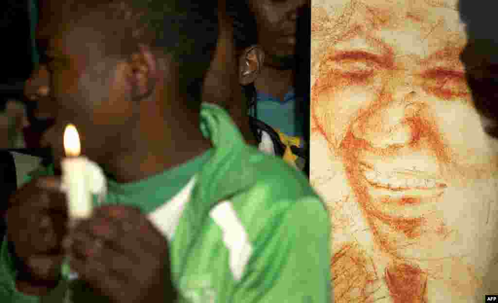 South Africa -- A well wisher holds a candle during a vigil outside the Mediclinic Heart Hospital in Pretoria, 25Jun2013