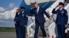 US President Trump exits Air Force One. On August 1, Trump posted on Truth Social that he was canceling a planned attack on Iran.